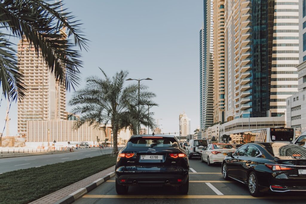 A street filled with lots of traffic next to tall buildings